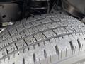 Close-up of a worn tire from a 2011 Ford Econoline showing detailed tread pattern and signs of use