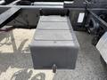 A black rectangular storage box placed under the chassis of a 2016 Freightliner 108SD truck