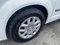 A close-up of a tire and wheel on a 2014 RAM Cargo Van showing a silver alloy wheel with five spokes and a black tire with the brand name BLIZ visible on the sidewall