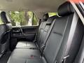 Interior view of the backseat of a 2021 Toyota 4Runner featuring black leather seats with headrests and seat belts