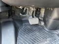 Foot pedals of a 2022 Mercedes-Benz Sprinter showing the gas and brake pedals with a rubber floor mat