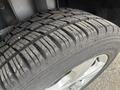 Close-up of a tire from a 2014 Ford Escape showing detailed tread pattern and alloy wheel rim