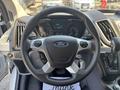 Steering wheel of a 2019 Ford Transit 350 with the Ford logo and control buttons visible