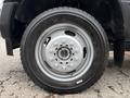 A close-up of a 2018 Ford F-550 wheel showcasing a silver rim with multiple lug holes and a black tire displaying the treads and size information