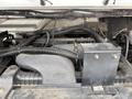 Close-up of the engine compartment of a 2012 Ford Econoline showing various integrated components and wiring