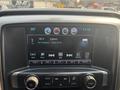Dashboard display of a 2017 Chevrolet Silverado 1500 showing radio settings and song information