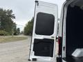A 2020 Ford Transit 250 van with an open rear door showing a black interior panel and a side compartment designed for cargo access