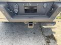 Rear view of a 2021 Ford F-150 showing the hitch receiver and trailer wiring connector
