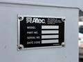 A metal identification plate attached to equipment displaying model and serial numbers along with a date code