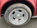 Close-up of a wheel and tire from a 1970 Chevrolet Corvette with a shiny silver rim and worn tire tread