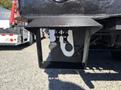 A close-up view of the tow hitch on a 2013 International 7500 showing two hitch pins protruding from the receiver