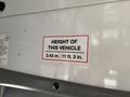 A 2020 Chevrolet Express vehicle with a sign indicating its height as 3.43 m or 11 ft 3 in
