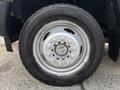 A silver wheel with a black tire from a 2017 Ford F-550 showing multiple lug nuts and a distinct tread pattern