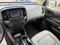 Interior view of a 2018 Chevrolet Colorado showcasing the dashboard audio system gear shift and seating area