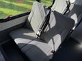 Interior seating of a 2021 Ford Econoline featuring two gray fabric seats with seat belts