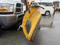 A 2011 Dodge Ram 5500 with a large yellow snow plow attachment mounted to the front