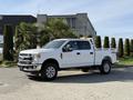 A 2021 Ford F-250 Super Duty truck in white with chrome accents parked on a driveway featuring a double cab and a truck bed