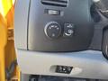 Control panel of a 2013 Chevrolet Silverado 1500 featuring dials for lighting and interior features