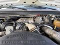Close-up of a 2008 Ford F-450 engine showcasing the Power Stroke V8 Turbo Diesel components and intricate metal piping
