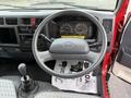 Interior view of a 2001 Toyota Dyna featuring a steering wheel gear stick and dashboard with speedometer and fuel gauge