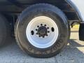 Close-up of a black tire from a 2013 International 7500 with white rim showing tread pattern and brand name Goodyear on the sidewall