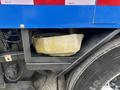A yellowed fabric bag secured in a compartment of a 2013 International DuraStar 4300 truck