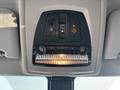 Interior overhead console of a 2013 BMW X3 featuring controls for lights and emergency functions