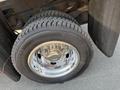 A chrome alloy wheel mounted on a rugged tire designed for a 2011 Dodge Ram 5500 with visible tread patterns