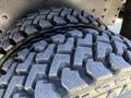 Close-up of a tire with deep treads designed for traction and durability suitable for heavy vehicles