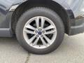 A close-up view of a 2017 Ford Edge wheel featuring a silver multi-spoke alloy rim and a Goodyear tire