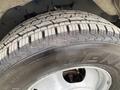 The close-up view of a tire from a 2020 Chevrolet Express showing detailed tread patterns and the brand name embossed on the sidewall
