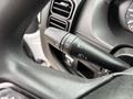 Close-up of the multifunction stalk on the steering column of a 2023 RAM Promaster 3500 used for controlling headlights and turn signals