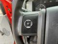 Close-up of a 2013 Ford F-550 steering wheel with a control button labeled SETUP INFO and RESET