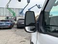 A 2020 Ford Transit 250 van with a side mirror visible in the foreground