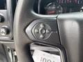 Close-up of a steering wheel control panel for cruise control featuring buttons for set, resume, and adjust functions