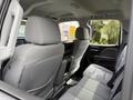 Interior view of a 2018 Chevrolet Silverado 1500 showcasing the back seat area with gray fabric upholstery and armrest storage
