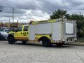A yellow 2010 Ford F-550 Super Duty fire truck with emergency lights and markings indicating it is for airside fire response