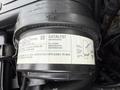 Close-up of a 2004 Chevrolet Express's emission control component labeled catalyst with specifications and regulatory information