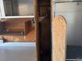 Interior view of a 2011 Workhorse W62 with wooden shelving and hooks for storage
