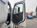 A 2006 Freightliner M2 106 truck door is open showcasing the interior design with a focus on the door handle and mirror