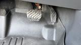 Close-up of the footwell area in a 2019 Nissan Kicks showing the brake and accelerator pedals with a textured surface beneath them