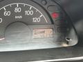 The dashboard of a 2010 Suzuki Carry showing the speedometer with a reading of 0 km/h and a fuel gauge indicating full