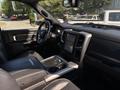 Interior view of a 2018 RAM 3500 featuring black leather seats a large central touchscreen and a modern dashboard design