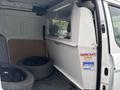A 2019 Ford Transit Connect interior with a transparent partition and two black wheels on the floor