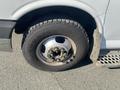 A close-up of a 2011 Chevrolet Express wheel showing a Goodyear tire mounted on a silver rim with visible lug nuts