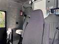 Interior of a 2020 Freightliner MT45 showing gray fabric seats in a commercial vehicle setup
