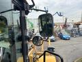 A 2012 Caterpillar 980 with a large bucket and heavy-duty chassis visible from the operator's perspective