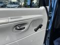 Interior door panel of a 2008 Ford E-350 featuring a door handle a manual window crank and speaker grille