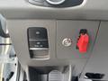 The dashboard of a 2021 Ford Transit-350 featuring various control buttons including a pull on switch and a red emergency switch