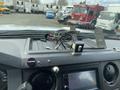 Interior dashboard of a 2015 Ford F-550 with a touchscreen display visible along with various electronic components and wiring